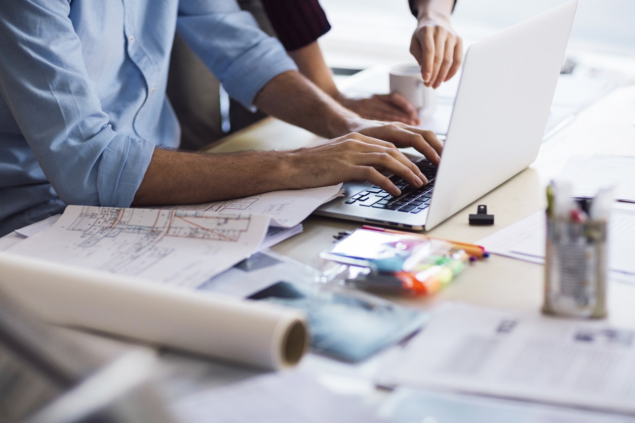 Architects using a laptop to complete rendering and designing tasks.